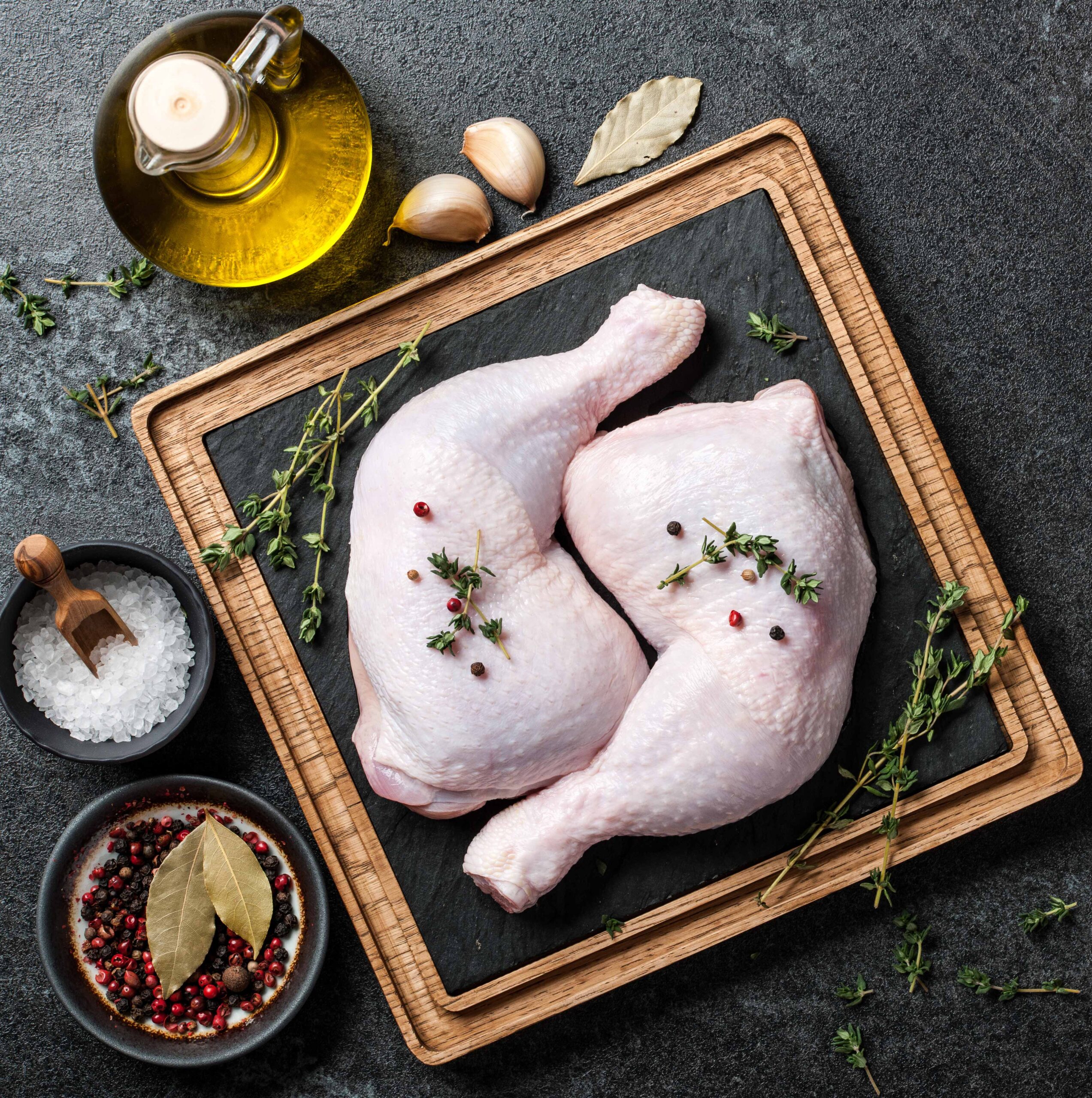 raw-chicken-legs-on-cutting-board-P2FYEWG