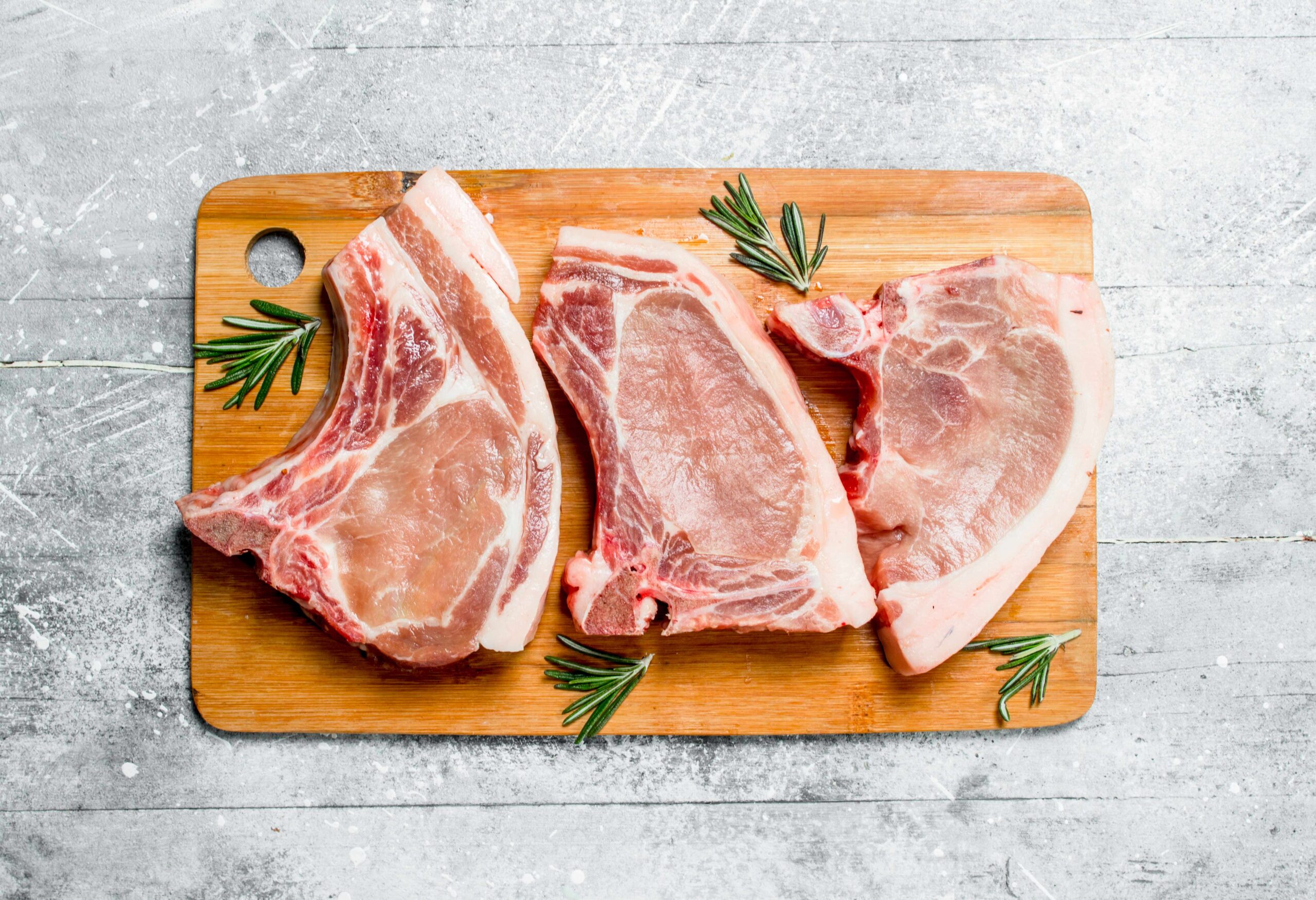 raw-pork-steak-on-the-bone-with-rosemary-6HK7V2B